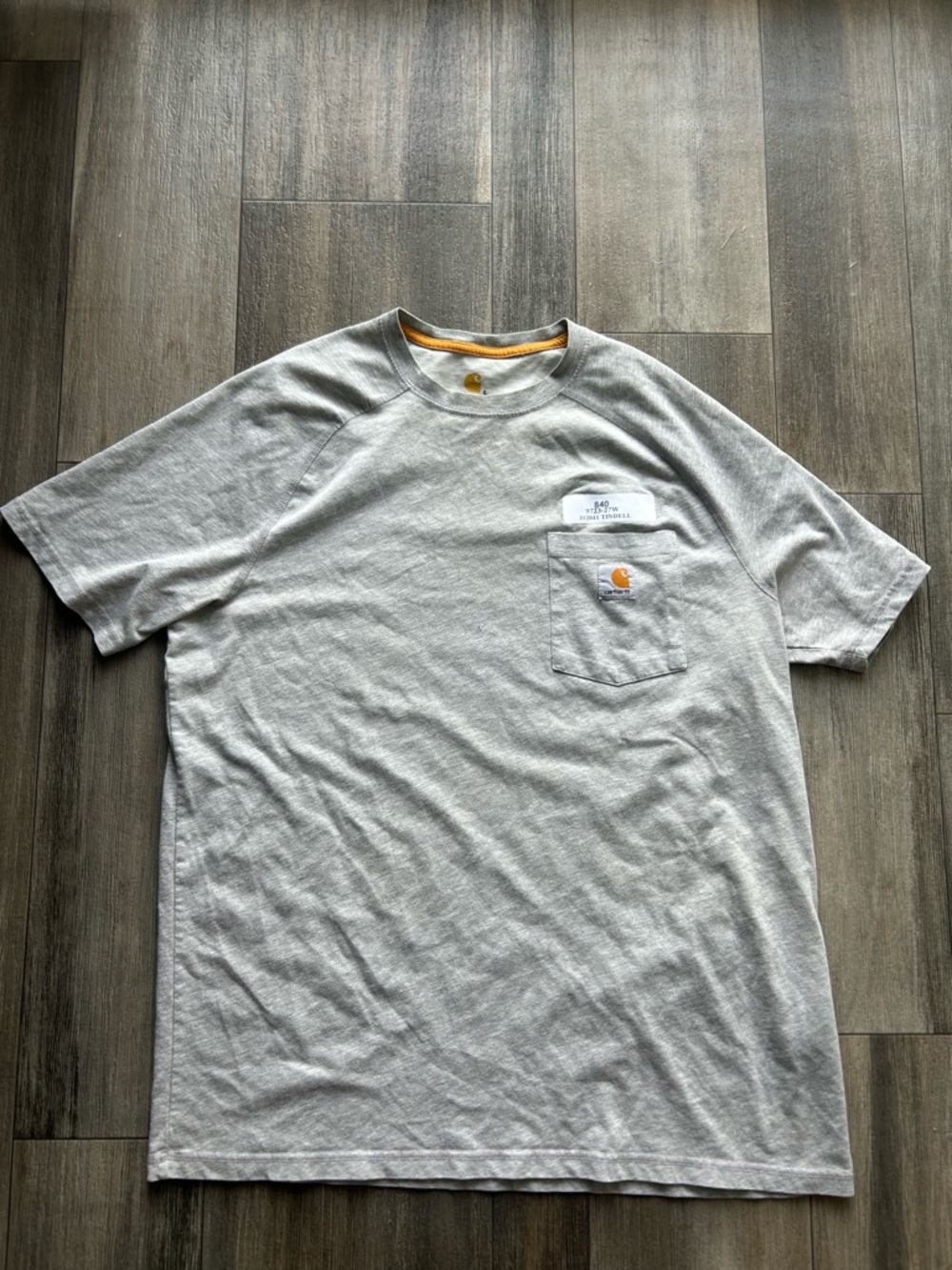 Carhartt grey pocket tee with "DOE" on back